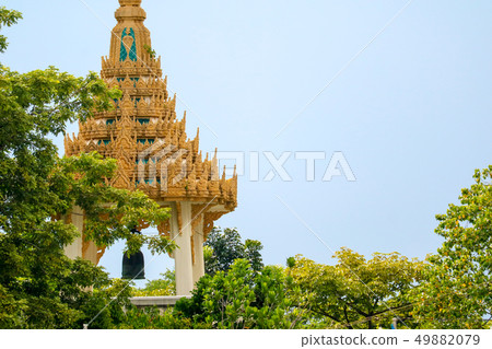 A bell tower in a temple Is covered by green trees A bell tower in a temple Is covered by green trees 49882079
