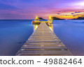 The bridge that stretches out the sea at sunset 49882464