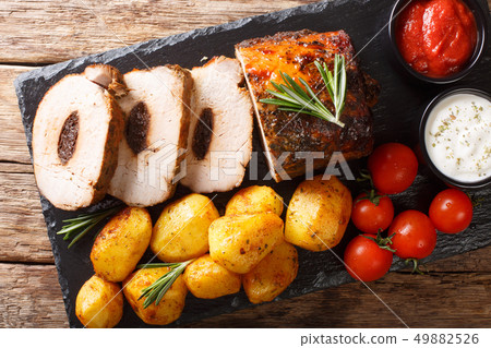 Festive baked pork stuffed with prunes with new 49882526