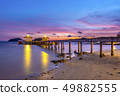 The bridge that stretches out the sea at sunset 49882555