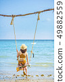 Women sitting on the beach swing, Koh Mak 49882559