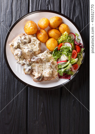 Pork steak in creamy mushroom sauce with a side Pork steak in creamy mushroom sauce with a side 49882770