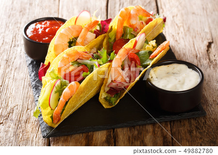 Tacos stuffed with shrimps, fresh vegetables and 49882780