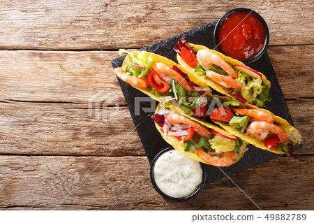 Crispy corn tacos with seafood fresh vegetables 49882789