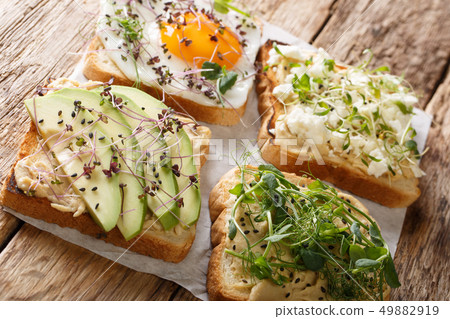 set of various toasts with hummus, avocado, feta 49882919