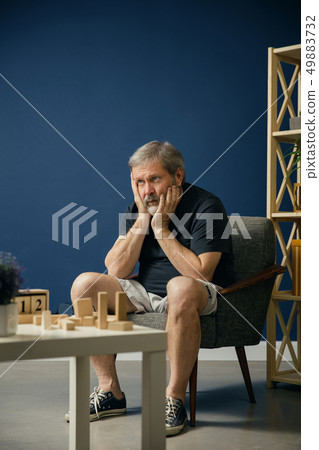 Old bearded man with alzheimer desease 49883732