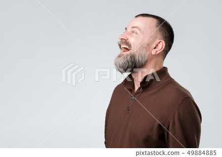 man with beard amazed and surprised looking up 49884885