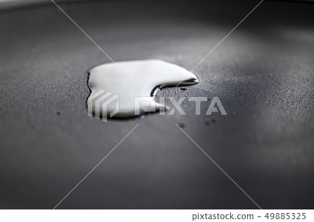 Olive oil on black frying pan. 49885325