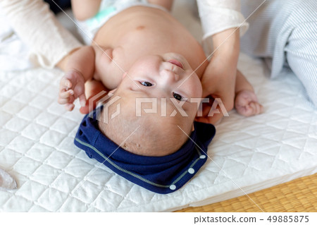 Baby changing clothes 49885875