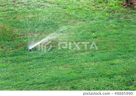 Sprinkler in garden watering the lawn. Automatic Sprinkler in garden watering the lawn. Automatic 49885990