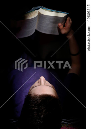 Teenager reading a book Teenager reading a book 49886245