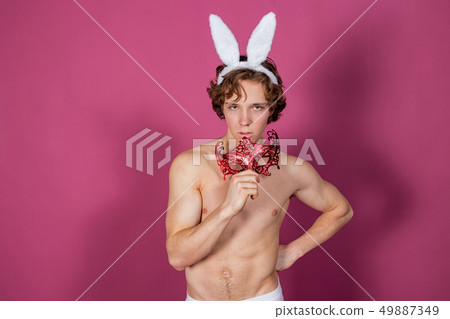 Funny naked guy wearing bunny ears and carnival - Stock Photo [49887349