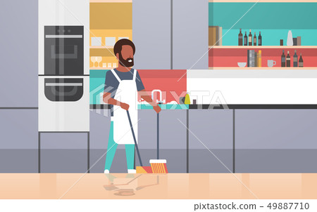 man sweeping floor with broom and scoop african american guy doing housework house cleaning concept 49887710