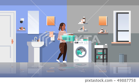 woman with clothes basket near washing machine african american housewife doing housework laundry 49887758