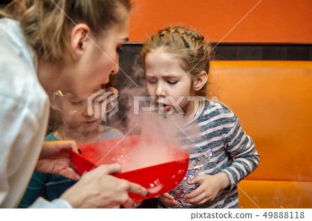 Chemical show for kids. Professor carried out chemical experiments with liquid nitrogen on Birthday Chemical show for kids. Professor carried out chemical experiments with liquid nitrogen on Birthday 49888118