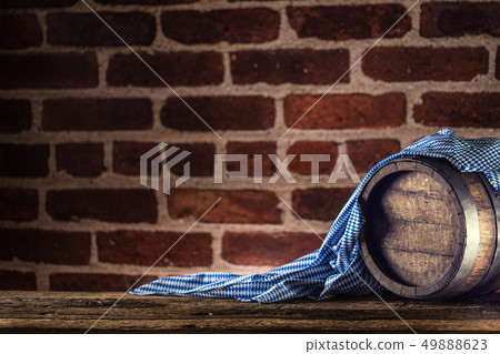 Oktoberfest wooden barrel and blue tablecloth on Oktoberfest wooden barrel and blue tablecloth on 49888623