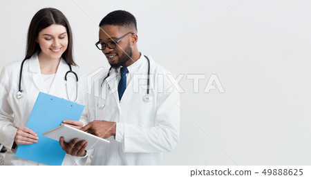 Doctor giving his colleague a piece of advice, light background Doctor giving his colleague a piece of advice, light background 49888625