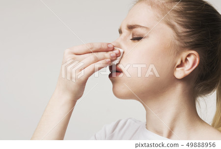 Young woman suffering from nose bleeding, panorama Young woman suffering from nose bleeding, panorama 49888956