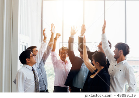 Cheerful diverse business people holding arms raised 49889139