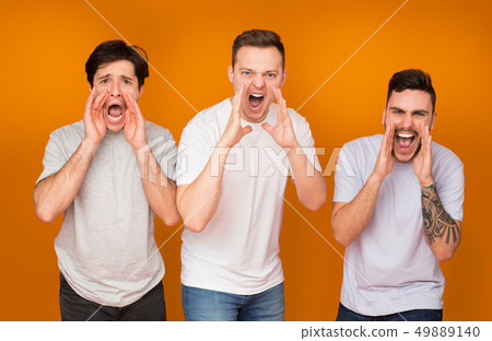 Men screaming loudly over orange studio background 49889140