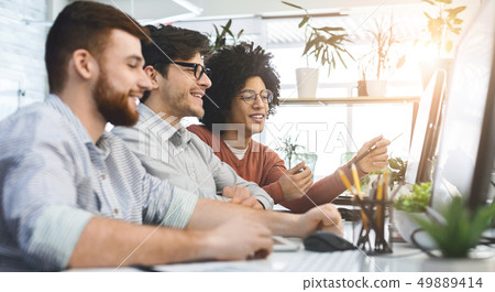 Group of young programmers developing data code 49889414