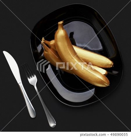 Golden bananas on plate Golden bananas on plate 49890035