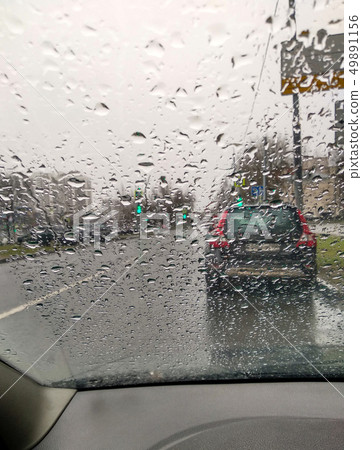 Raindrops on the windshield. View from inside the car Raindrops on the windshield. View from inside the car 49891156