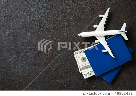 Airplane model, two passports and money on a dark Airplane model, two passports and money on a dark 49891451