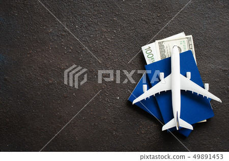 Airplane model, two passports and money on a dark Airplane model, two passports and money on a dark 49891453