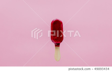 Cherry ice lolly on pink background. 49893434