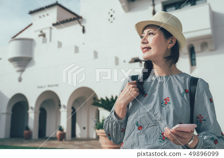 girl hold cellphone smiling look aside 49896099