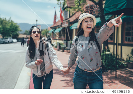 sister holding cellphone with online map. 49896126