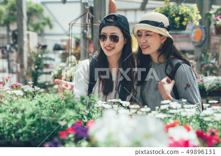 two beautiful Asian women buying flowers happily 49896131