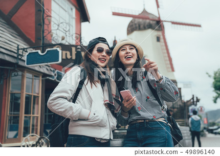 girls standing on street city with windmill 49896140