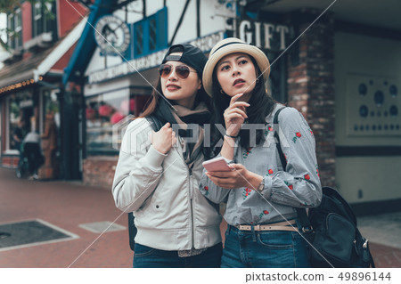 tourist women try navigate with online map 49896144
