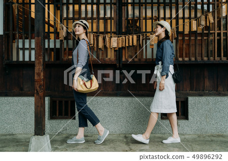 women visit japanese house walk in garden pathway 49896292