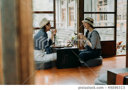 friends sit wooden house holding matcha tea bowl 49896313
