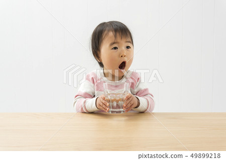 A girl drinking water 49899218