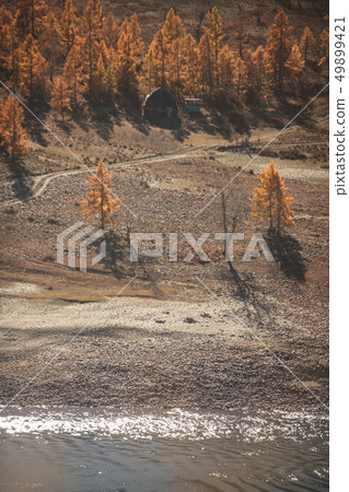 Mongolian yurt and ruined house near the large mountain and river. Autumn landscape. Altai mountains Mongolian yurt and ruined house near the large mountain and river. Autumn landscape. Altai mountains 49899421