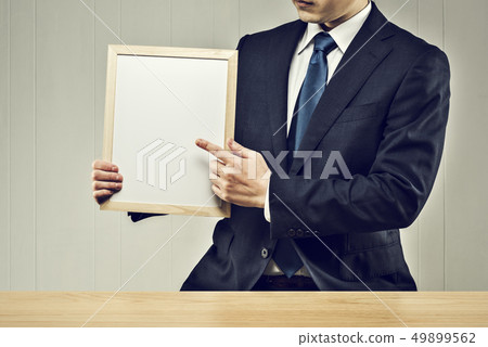 Men holding a board Men holding a board 49899562