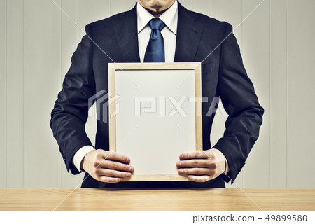 Men holding a board Men holding a board 49899580