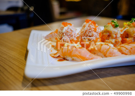 Salmon Sushi is a popular Japanese food. Salmon Sushi is a popular Japanese food. 49900998