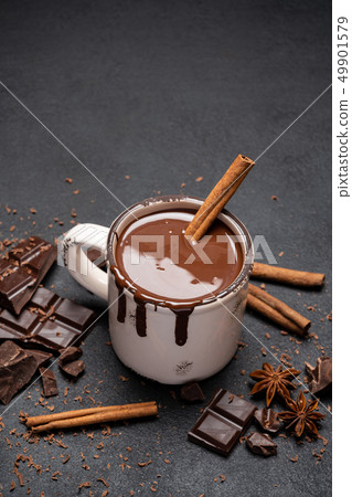 Cup of hot chocolate and pieces of chocolat on dark concrete background Cup of hot chocolate and pieces of chocolat on dark concrete background 49901579