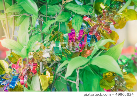 Brilliant colorful tinsel hang on tree Brilliant colorful tinsel hang on tree 49903824