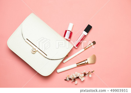 Makeup bag with cosmetics isolated on living coral 49903931