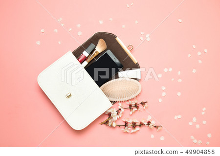Makeup bag with cosmetics isolated on living coral 49904858