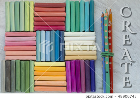Rainbow pastel crayons and bunch of pencils, 49906745