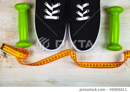 Sneakers, dumbbells and measuring tape Sneakers, dumbbells and measuring tape 49909811