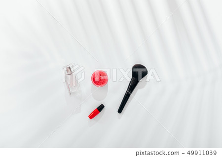 Pink blush, brush, lipstick and perfume bottle Pink blush, brush, lipstick and perfume bottle 49911039