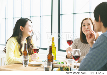 Young men and women having a meal Party image 49911237
